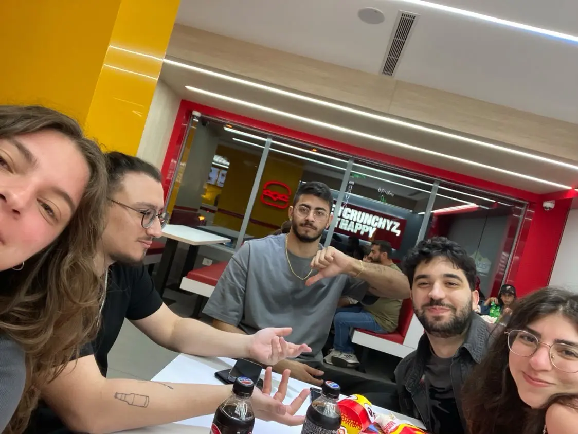 Five friends crammed into a fast-food booth