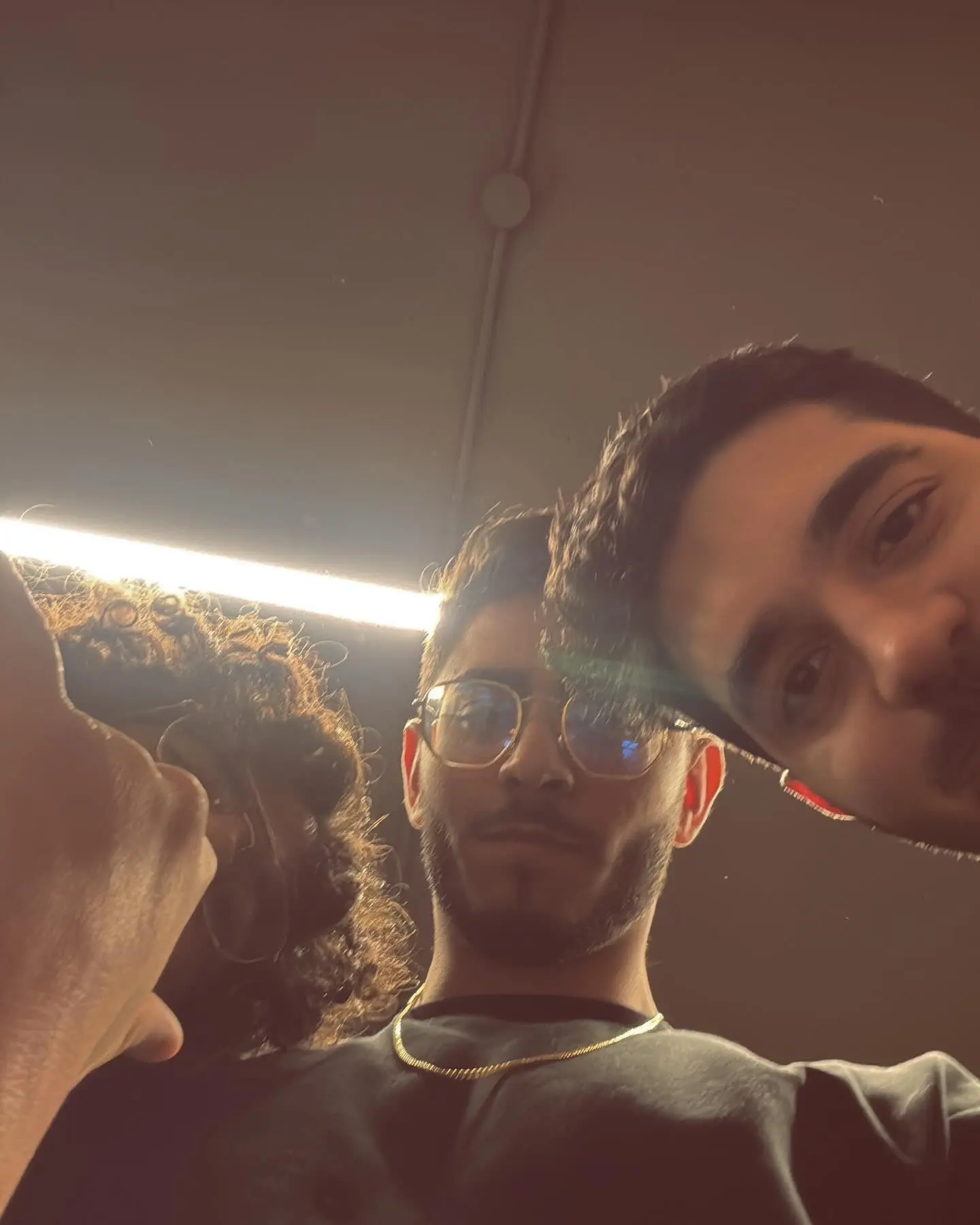 Three friends mid-laugh at a party