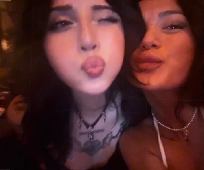 Two friends pulling faces at the camera on a night out
